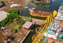 crane truck on dock with boats