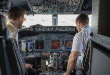 two pilots sitting inside plane