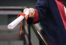 person holding white scroll