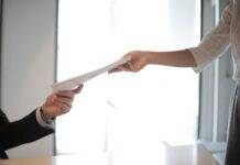 job applicant passing her documents