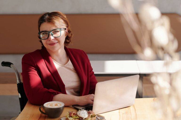woman in red blazer wearing black framed eyeglasses