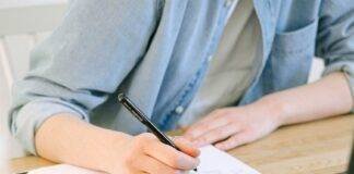 person writing on a notebook