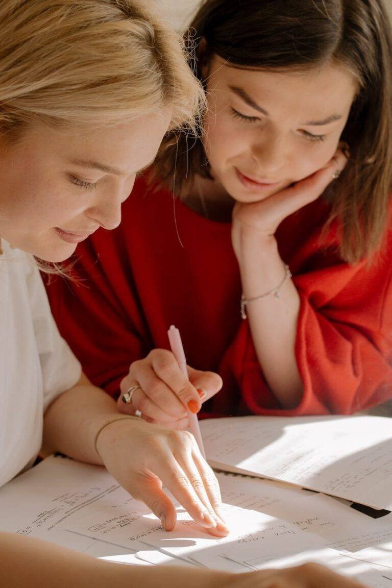 woman in red shirt holding pen writing on white paper
