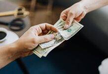 hands holding us dollar bills