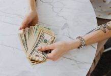 person holding us dollar bills