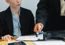 crop colleagues in formal wear checking documents
