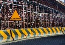 yellow and black road concrete barrier
