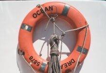 lifebuoy and tied rope hanging in yacht