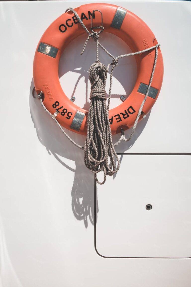 lifebuoy and tied rope hanging in yacht