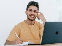 dreamy ethnic businessman thinking about project