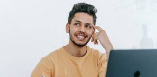 dreamy ethnic businessman thinking about project