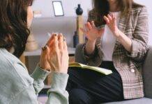 crop unrecognizable female psychologist and patient discussing mental problems during session