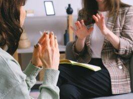 crop unrecognizable female psychologist and patient discussing mental problems during session