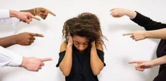 a woman covering her ears
