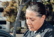 policewoman giving a traffic violation ticket