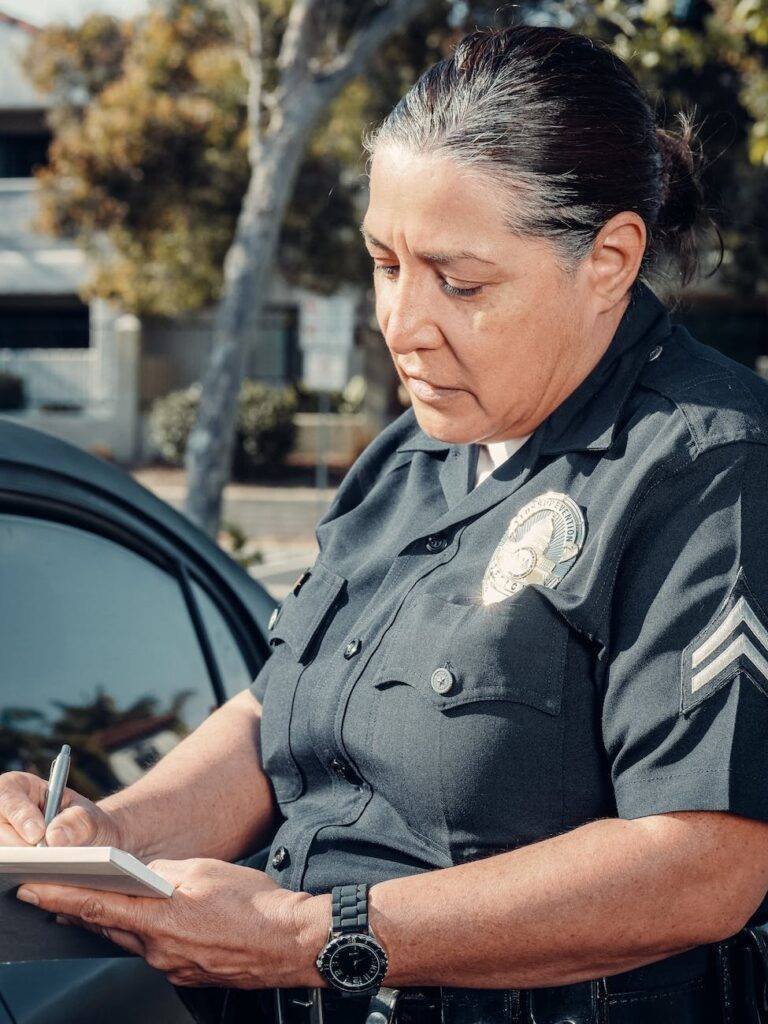 policewoman giving a traffic violation ticket