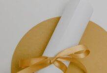 a certificate beside white paper with message