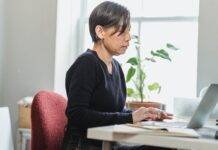 woman browsing the internet by using a laptop