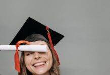 photo of woman in academic dress holding diploma