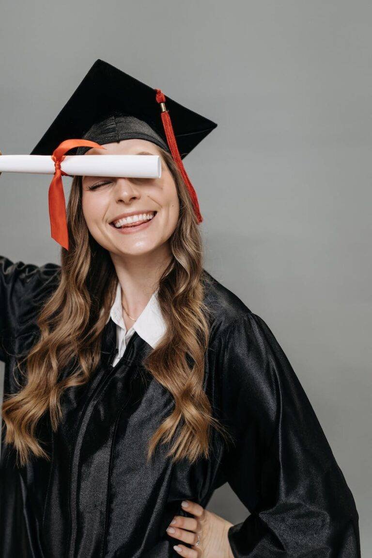 photo of woman in academic dress holding diploma