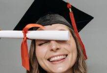 photo of woman in academic dress holding diploma