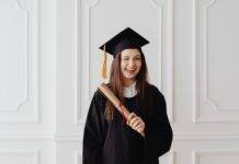 woman in academic dress smiling with her tongue out