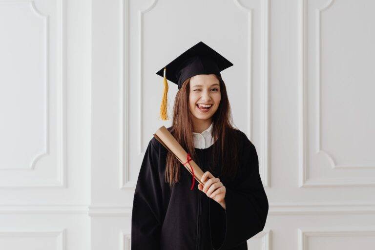 woman in academic dress smiling with her tongue out