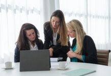 a group of women discussing about work