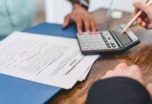 real estate agent calculating an amount to a client