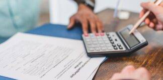 real estate agent calculating an amount to a client