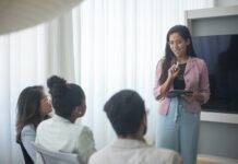 a woman giving presentation to colleagues