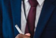 person in blue suit writing on notebook