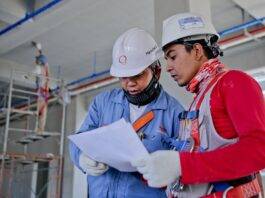 two man holding white paper