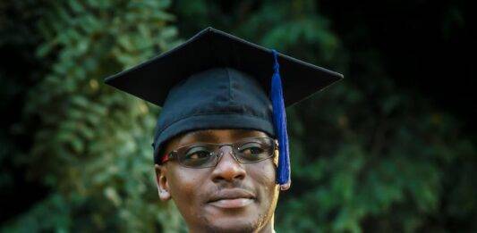 man wearing graduation gown