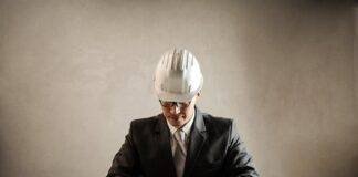professional architect working with draft in office