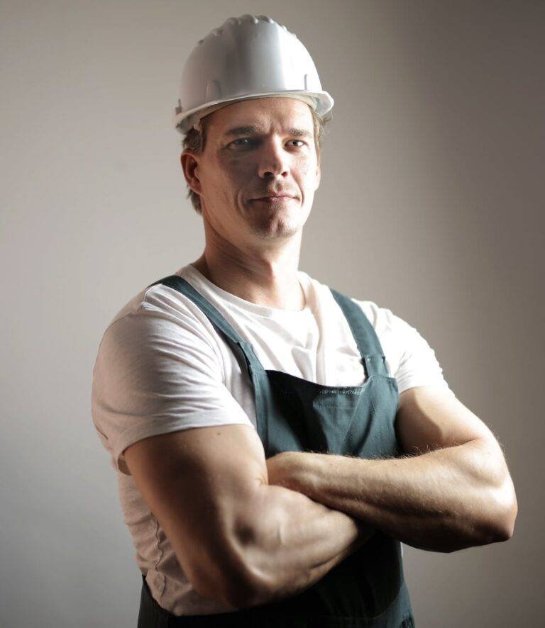 serious adult constructor in helmet and uniform