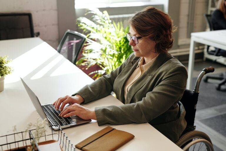 a woman in eyeglasses while using laptop