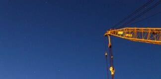 a yellow crane under blue sky