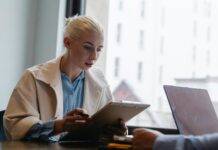 serious businesswoman reading documents in office