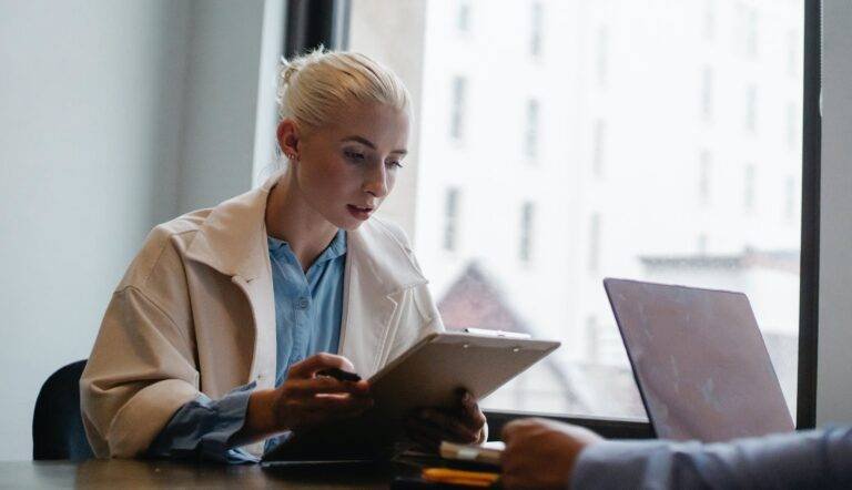 serious businesswoman reading documents in office