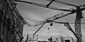 silhouettes of builders on construction site