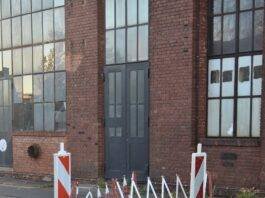railings around hatch on asphalt carriageway
