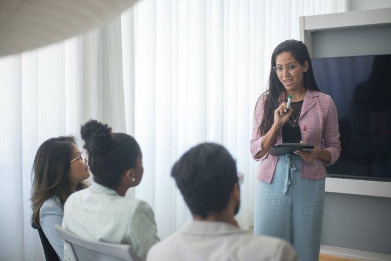 a woman giving presentation to colleagues
