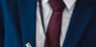 person in blue suit writing on notebook
