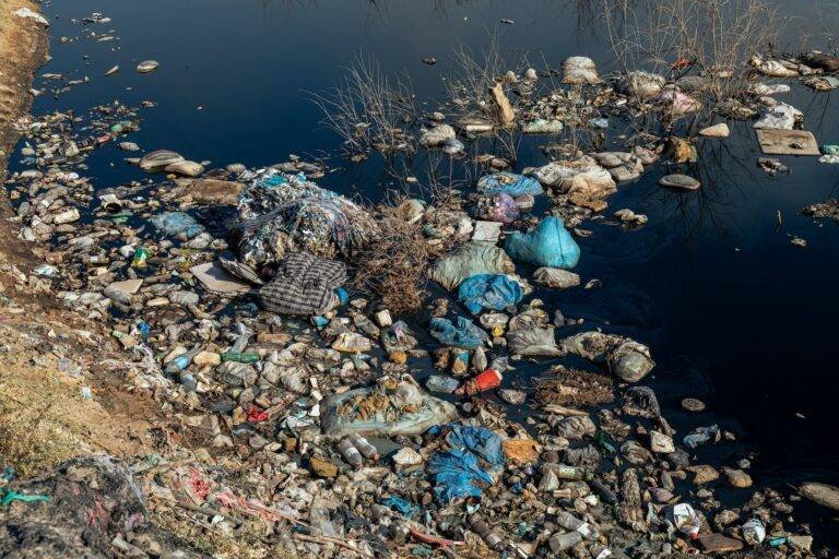 a river with garbage and trash in it