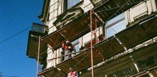 men on brown scaffolding