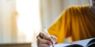 selective focus photo of person writing