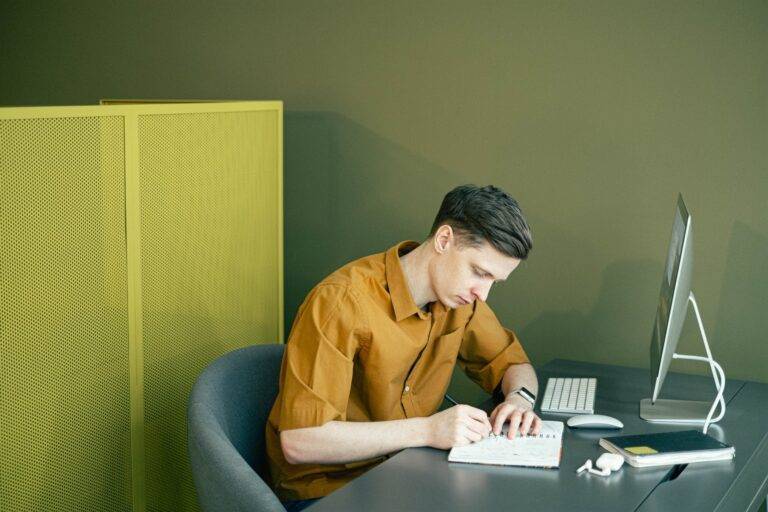 man drawing on his sketchbook