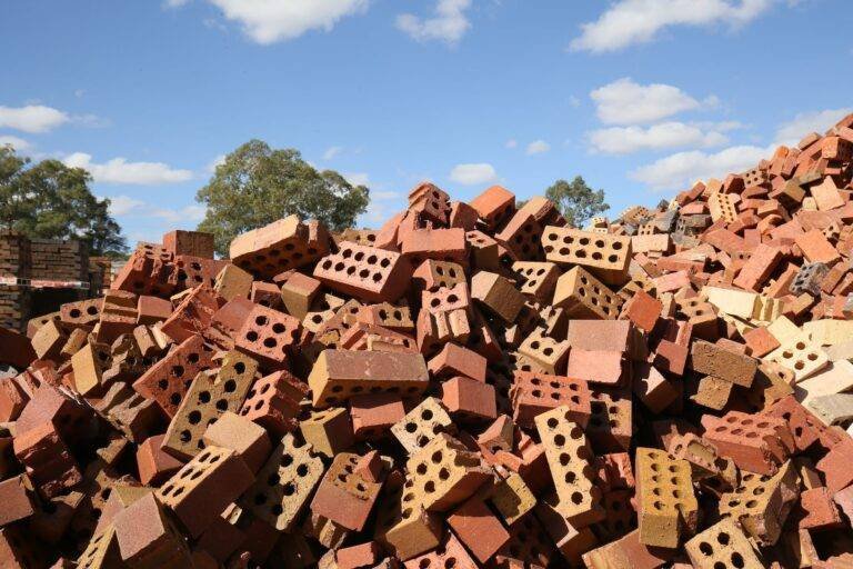 heap of red broken bricks in construction area