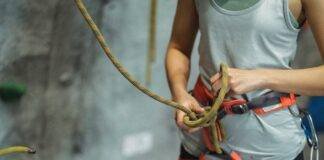crop climber tying safety rope during training